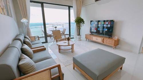 a living room with a couch and a tv at Sea View Country Garden Danga Bay by LionsBay in Johor Bahru