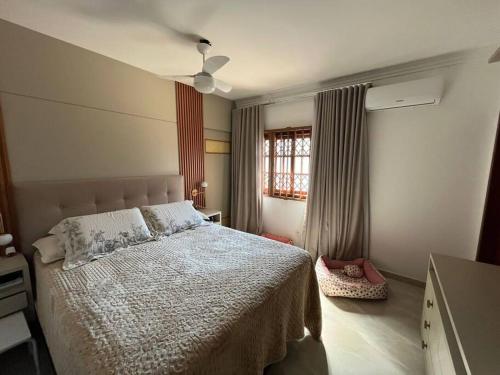 a bedroom with a bed and a ceiling fan at Casa em Governador Celso Ramos in Governador Celso Ramos