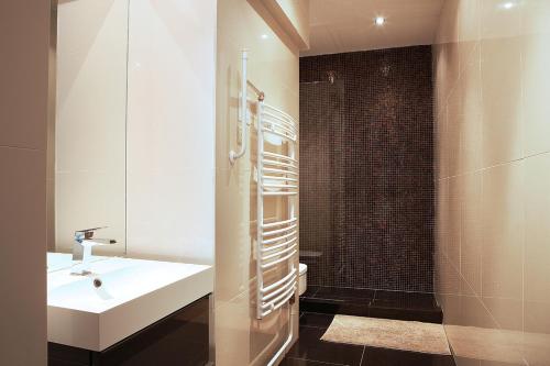 a bathroom with a sink and a shower at New Design Apartment - Fashion Street in Budapest