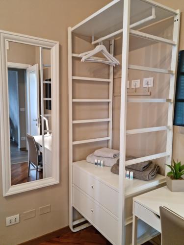 a dressing room with a mirror and a white dresser at Alemanni54 - Apartment in Bologna