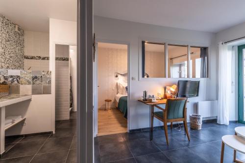 a living room with a table and a television in a room at Manoir De Rigourdaine in Plouër-sur-Rance