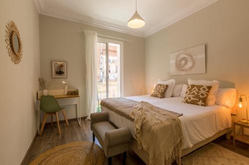 a bedroom with a bed with a chair and a window at 13PAR1004 - Fabulous apartment in the heart of Barcelona in Barcelona