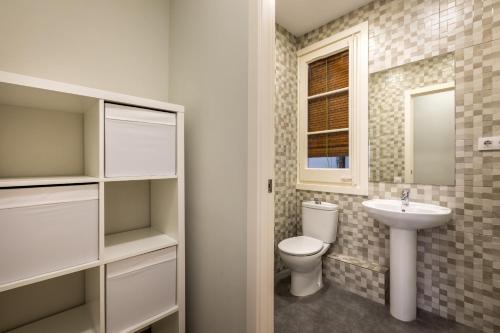 a bathroom with a toilet and a sink at 13PAR1004 - Fabulous apartment in the heart of Barcelona in Barcelona