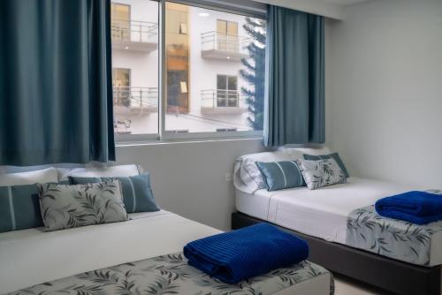 Postel nebo postele na pokoji v ubytování El Oscar Hotel