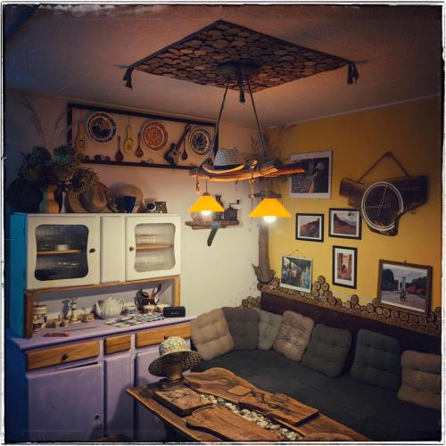 a kitchen with a couch and a table in a room at Cinderella Guitars in Czartoria