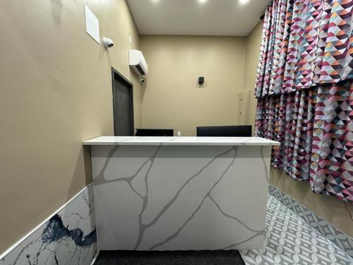 a reception desk in a waiting room with a curtain at Moon Hotel Brooklyn in Brooklyn