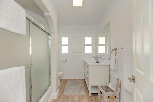 a white bathroom with a sink and a shower at Lovely White Beach House in Redondo Beach