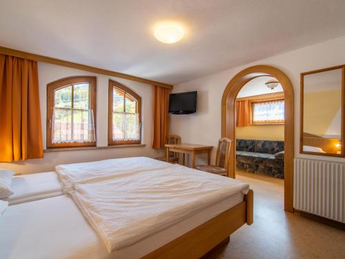 a bedroom with a large bed and a television at Haus Stock in Zell am Ziller