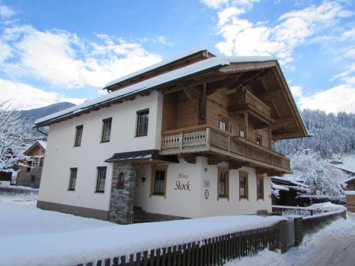 a large wooden house with a balcony in the snow at Haus Stock in Zell am Ziller