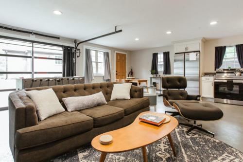 a living room with a couch and a table at Greenway Garage with Firepit in Athens