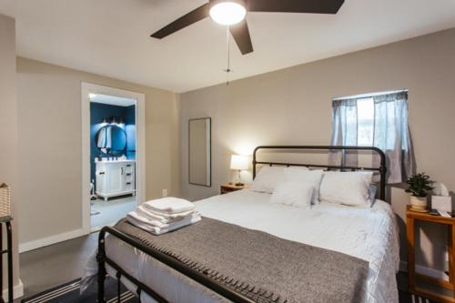 a bedroom with a bed with a ceiling fan at Greenway Garage with Firepit in Athens