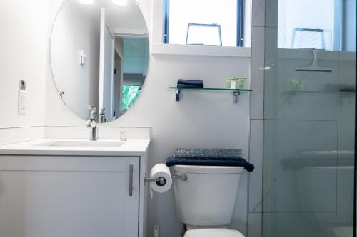 a bathroom with a toilet and a sink and a mirror at Poplars Motel on the lake in Osoyoos