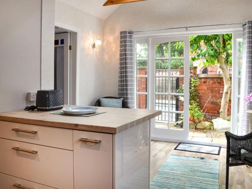 a kitchen with a counter and a sliding glass door at The Stables in Hedon
