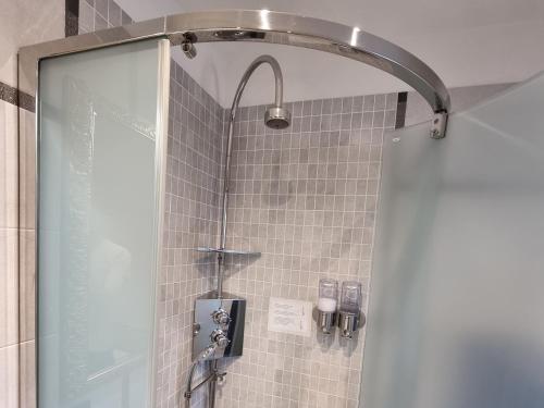 a shower with a glass door in a bathroom at Maison Bodroz appartamento Charme in Aosta