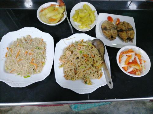 a group of plates of food on a table at Werala Beach Resort in Kalpitiya