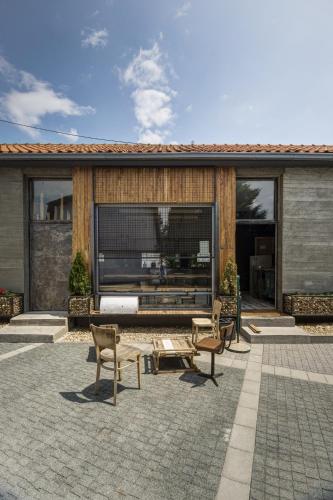 a patio with two chairs and a table at Hostel Fair and Square in Belgrade