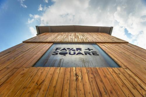 a tall building with a sign on the top of it at Hostel Fair and Square in Belgrade
