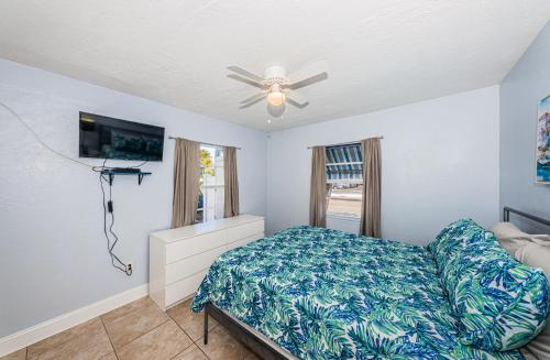 1 dormitorio con 1 cama y ventilador de techo en Blue Water Beachside Villa 1 en Clearwater Beach