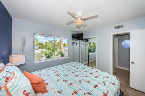 a bedroom with a bed and a ceiling fan at Blue Water Beachside villa 2 in Clearwater Beach