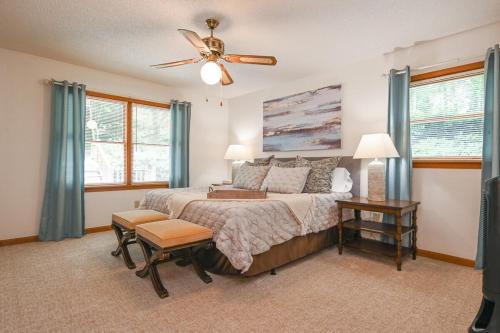 a bedroom with a bed and a ceiling fan at Lakefront with Dock and Hot Tub! in Toccoa