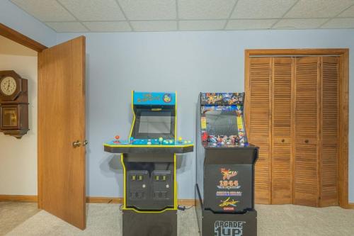 une chambre avec deux machines de jeux vidéo à côté d'une porte dans l'établissement Lakefront with Dock and Hot Tub!, à Toccoa