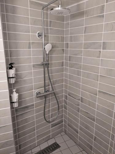 a shower with a shower head in a bathroom at Norichanchi in Nozawa Onsen