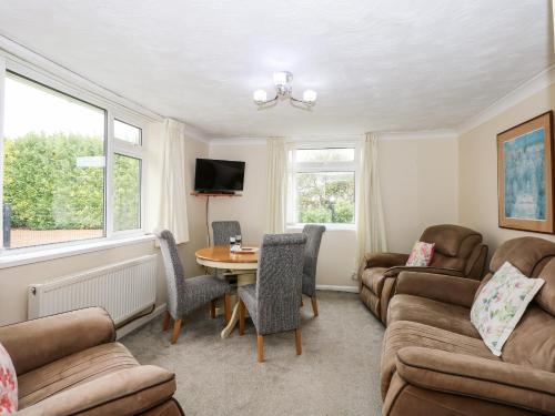 a living room with a couch and a table at Sheppard's Hut in Terrington Saint Clement