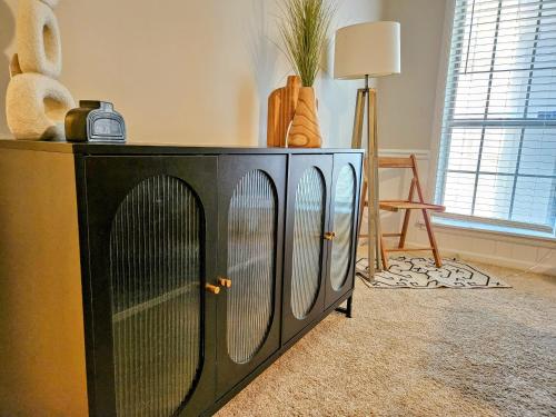 a large black cabinet with doors in a room at VillaQuèFrancia near Elvis Presley's Graceland 6 mins from Airport, Shuttle, & Rental Vehicle in Memphis