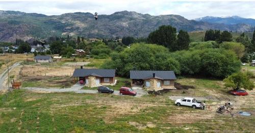 a person is flying over a house in a field at Rincón Bonito in El Hoyo