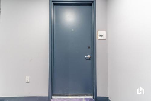 a blue door in a building with a sign on it at Downtown Miami Condos by Lua Host in Miami