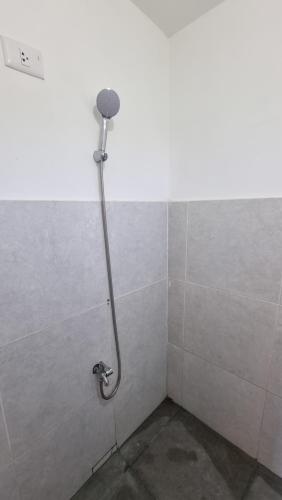 a shower in a corner of a bathroom at Riverfront Residence in San Carlos, Pangasinan 