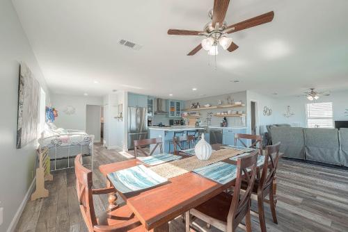 a dining room and kitchen with a table and chairs at Surfside Beachfront Dream in Surfside Beach