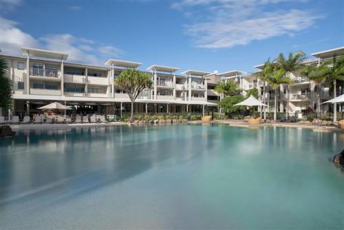 a large swimming pool in front of a hotel at Peppers Salt Resort & Spa 2 br luxury spa suite in Kingscliff