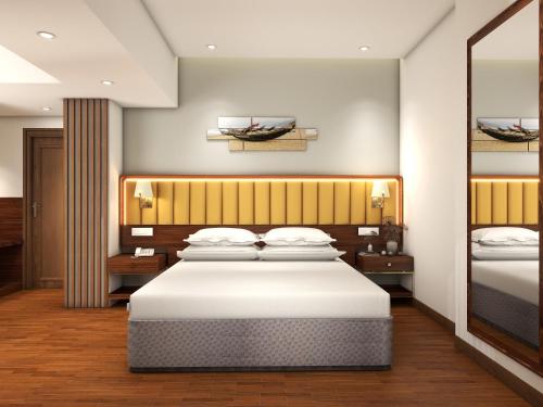 a bedroom with a large white bed in it at Park Inn by Radisson Goa Candolim in Candolim