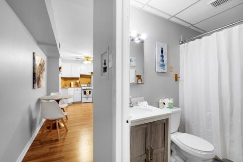 a white bathroom with a toilet and a sink at 1 Bdrm Flat In Bella Vista in Philadelphia