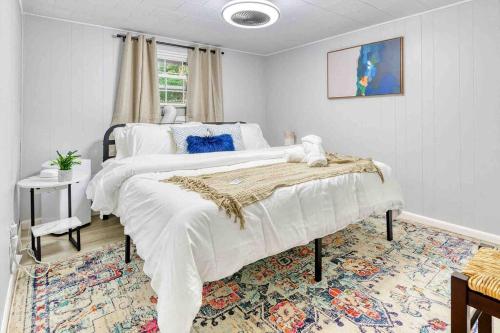 a bedroom with a large bed and a rug at Hot Tub Fire Pit Dog Friendly in Pocono Lake