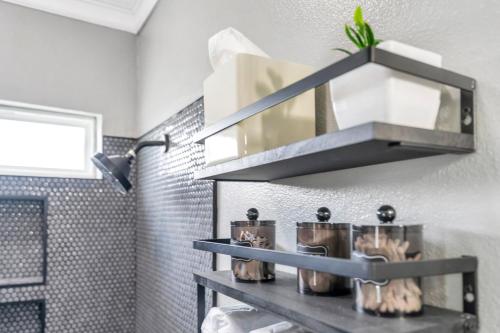 a bathroom with a shelf with pots and pans at River Cottage near the Airport in Saint Rose