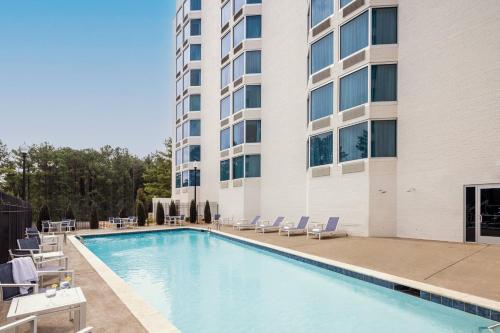 a swimming pool in front of a building at Crowne Plaza Atlanta NE - Norcross by IHG in Norcross