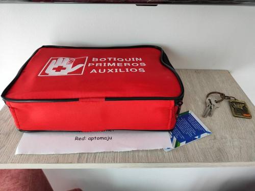 a red suitcase sitting on top of a table at Apartamento con terraza privada in Restrepo