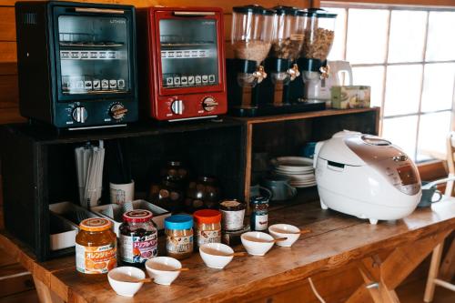 a counter with cups of food and a mixer on it at Alpenglow Lodges Ginkei in Niseko