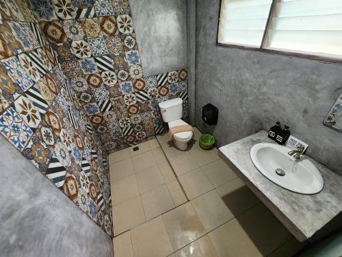 a bathroom with a sink and a toilet at Tiki Beach Koh Phangan Beach Restaurant Bar and Coworking in Ban Tai