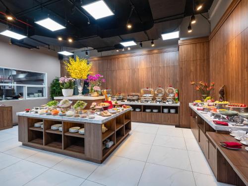a large kitchen with lots of food on display at Nesta - The Grand Hao Nam in Hanoi