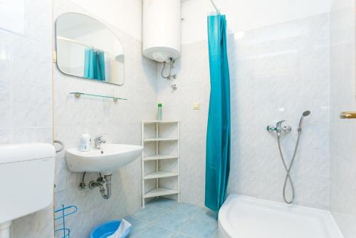 a bathroom with a shower and a toilet and a sink at Apartments by the sea Zivogosce - Porat, Makarska - 20207 in Igrane
