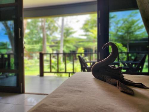 a bird statue sitting on top of a table at Tiki Beach Koh Phangan Beach Restaurant Bar and Coworking in Ban Tai