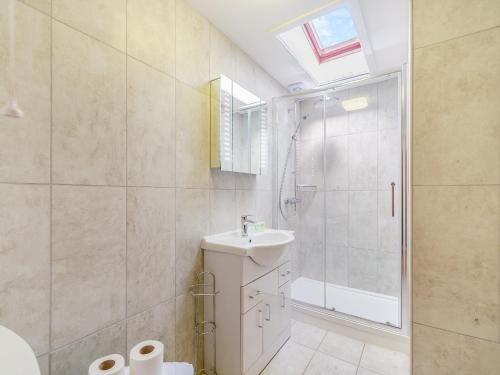 a white bathroom with a sink and a shower at Primrose Cottage- Uk45597 in Verwick