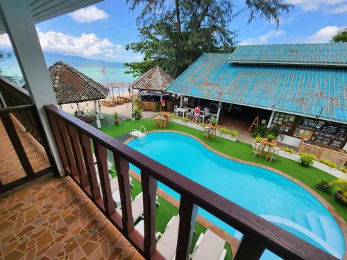 a view from the balcony of a resort with a swimming pool at Tiki Beach Koh Phangan Beach Restaurant Bar and Coworking in Ban Tai