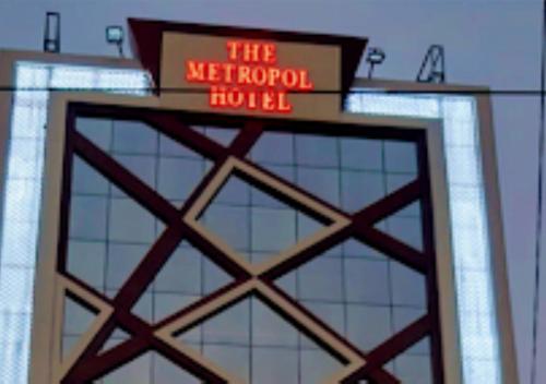 a building with a neon sign on top of it at The Metropol Hotel Bihar in Siwān