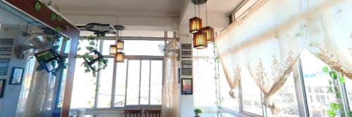 a room with a large window and some lights at Hotel Sunrise Imphal in Imphal