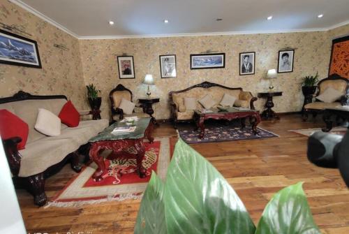 a living room with two couches and a table at Jain Group- Keepsa Residency & Spa, Gangtok in Gangtok