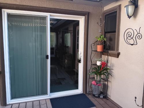 a sliding glass door on a porch with potted plants at Arden Park Charm in Sacramento